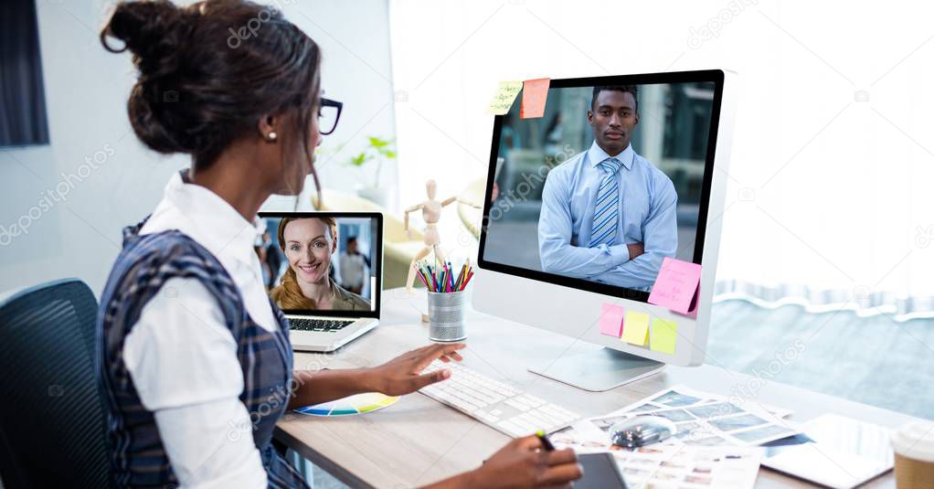 Businesswoman video conferencing on computer in office