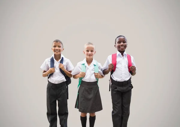 Niños de la escuela frente a fondo gris —  Fotos de Stock