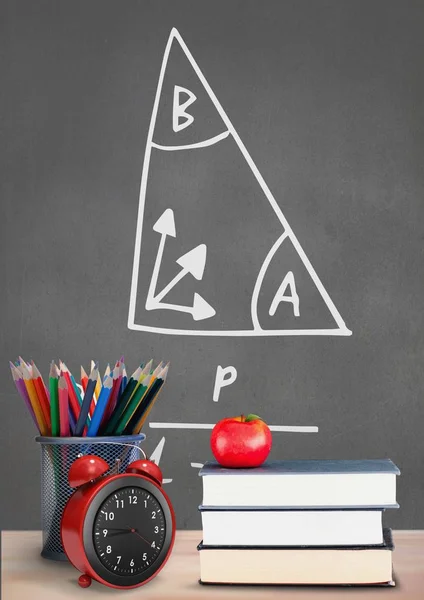 Books on the table against grey blackboard — Stock Photo, Image