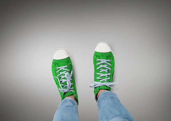 Green shoes on feet with grey background — Stock Photo, Image