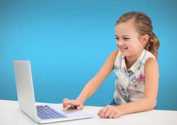 Girl on laptop with blue wall — Stock Photo, Image