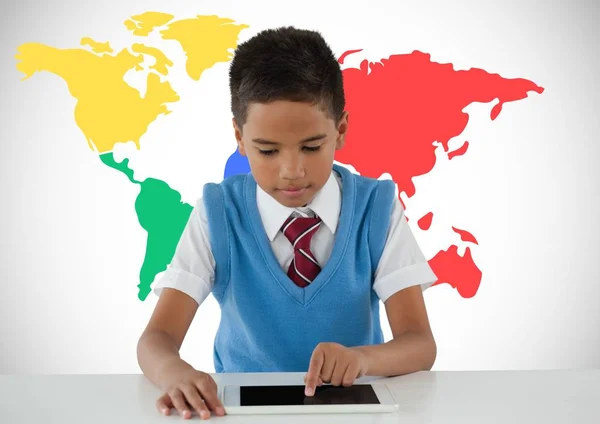 Schoolboy on tablet with world map — Stock Photo, Image