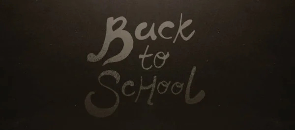 Back to school text against blackboard — Stock Photo, Image