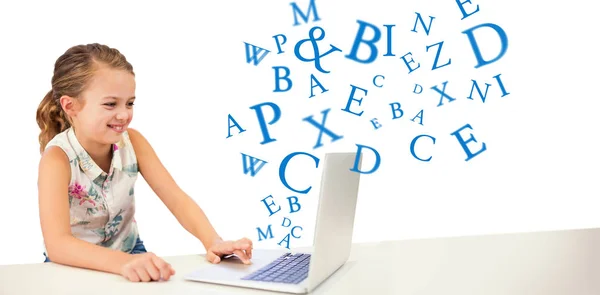 Girl using laptop at table — Stock Photo, Image