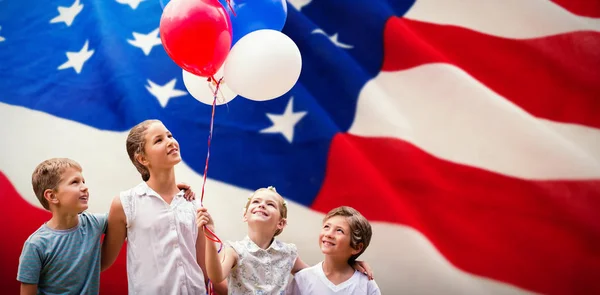 Chica con amigos sosteniendo globos de colores — Foto de Stock