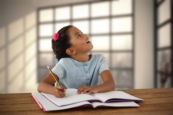 Ragazza guardando verso l'alto mentre scrive — Foto Stock