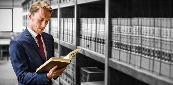 Handsome lawyer reading in law library 