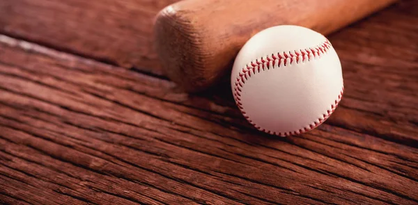 Baseball bat and ball on wooden table — Stock Photo, Image