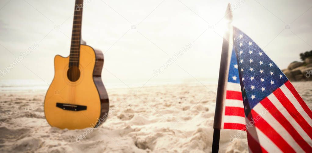 guitar in sand and usa flag 