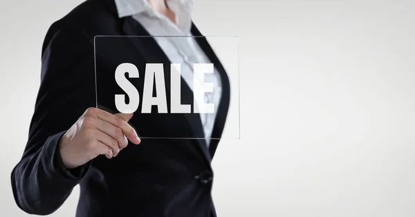 Business woman holding a glass with sale text — Stock Photo, Image