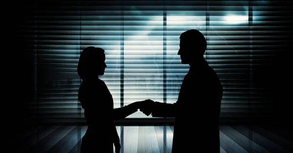 Business handshake silhouette against building