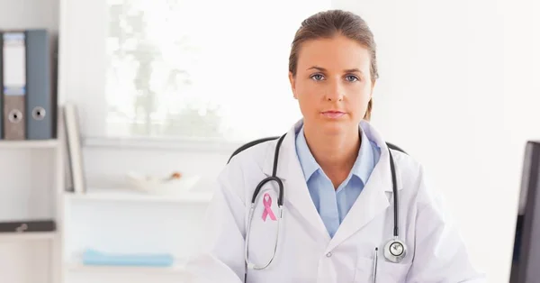Doctor woman with breast cancer ribbon — Stock Photo, Image