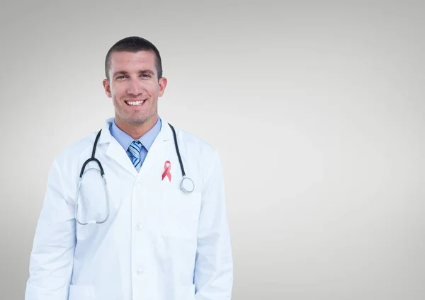 Doctor with breast cancer awareness ribbon — Stock Photo, Image