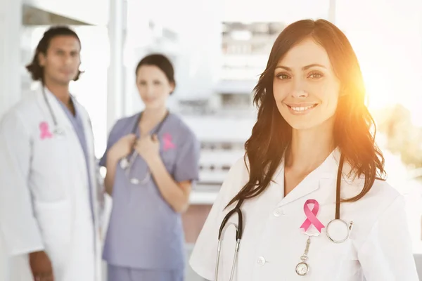 Cancer awareness ribbon against nurse — Stock Photo, Image