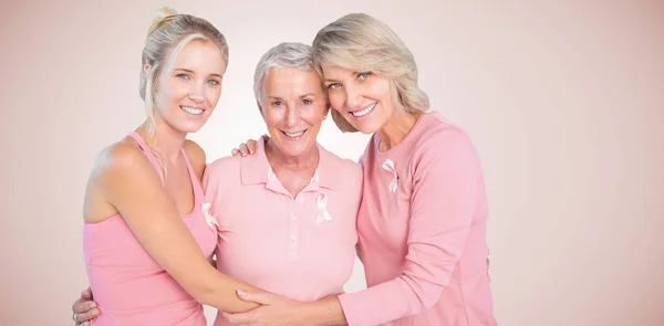 Daughters with mother supporting breast cancer awareness — Stock Photo, Image