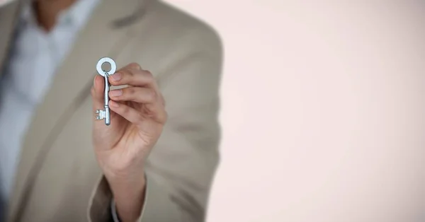 Woman Holding key in front of vignette — Stock Photo, Image