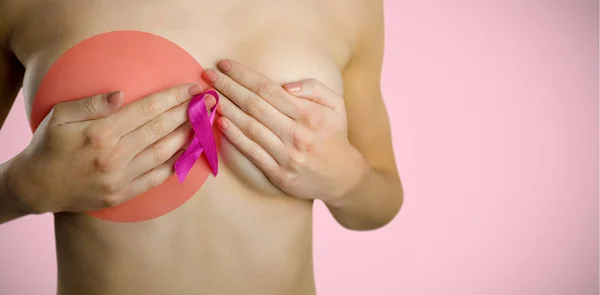 naked woman with pink ribbon covering breast