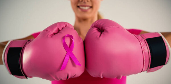 woman with boxing gloves and pink ribbon
