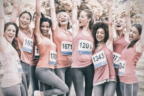 Female breast cancer marathon runners cheering — Stock Photo, Image