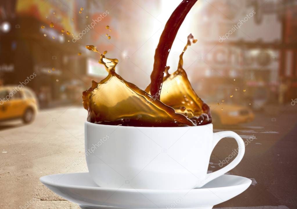 Coffee being poured into white cup 