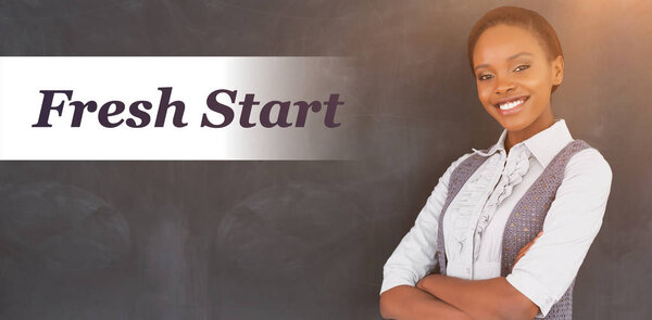 teacher smiling with arms crossed