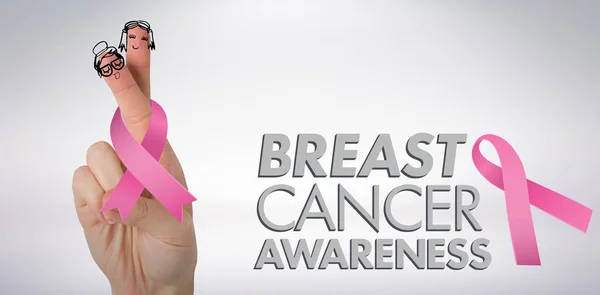 Ręka trzyma wstążki świadomości raka piersi — Zdjęcie stockowe