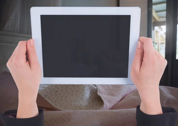 Hand holding tablet at home — Stock Photo, Image