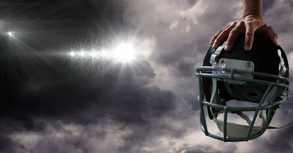 American football helmet in hand — Stock Photo, Image