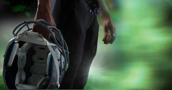 American football player holding helmet Stock Image