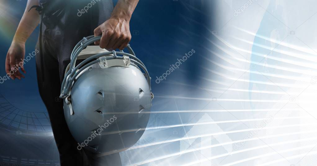 American football player holding helmet 