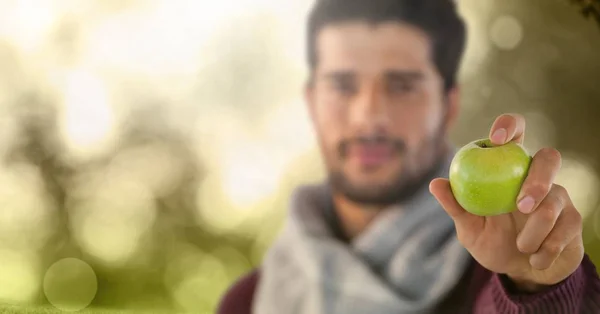 Man in Autumn with apple in forest — Stock Photo, Image