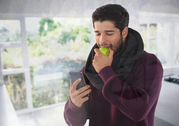 Man i höst med äpple och telefon — Stockfoto