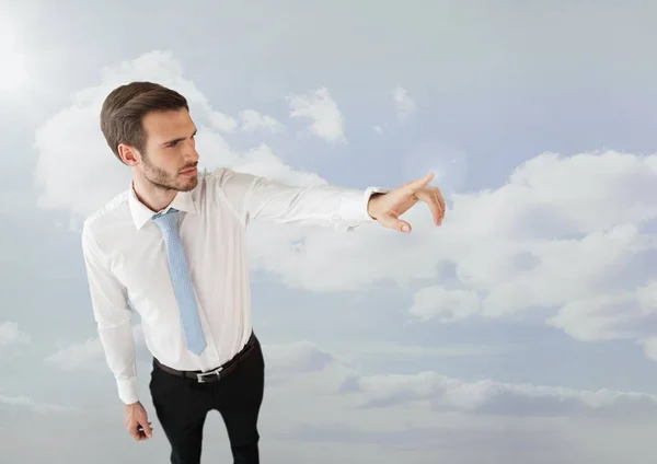 Businessman pointing in clouds — Stock Photo, Image