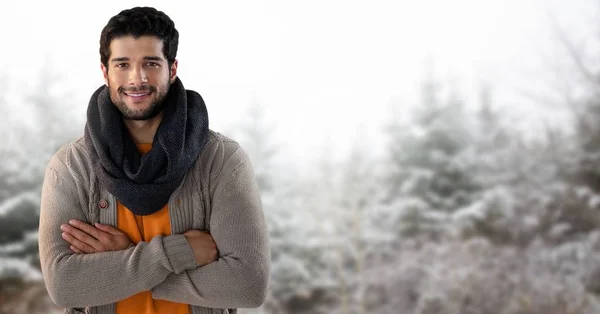 Man with scarf in snow forest