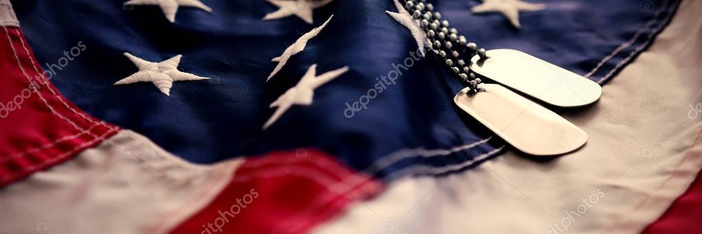 Dog tag chains on striped American flag
