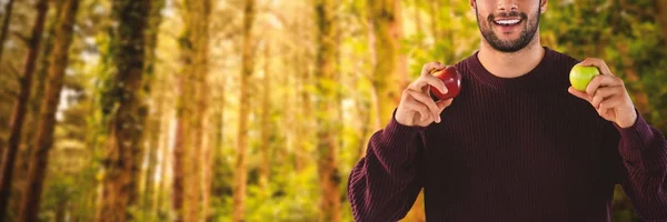 Smiling man holding apples — Stock Photo, Image