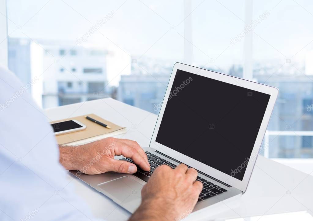 Businessman hands at desk with laptop 