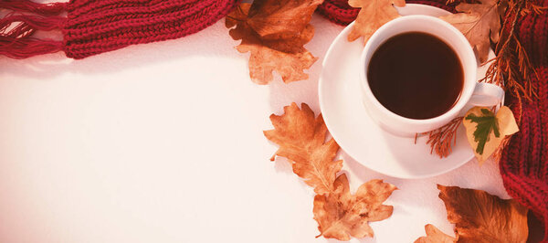 Cup of black tea with autumn leaves 