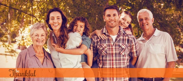 Happy family standing together in park — Stock Photo, Image