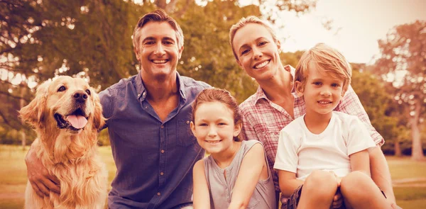 Family enjoying with dog at park — Stock Photo, Image