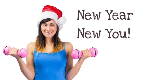 New year New you text and fit woman lifting weights in Santa hat — Stock Photo, Image