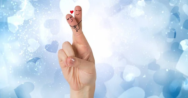 Digital composite of Valentine\'s fingers love couple and blue hearts