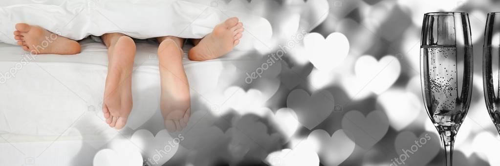 Digital composite of Couple's feet with valentine's love transition hearts and champagne