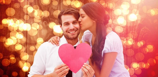 Pretty Brunette Giving Boyfriend Kiss Her Heart Blurred Orange Light — Stock Photo, Image