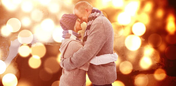 Happy Mature Couple Winter Clothes Hugging Blurred Yellow Light — Stock Photo, Image