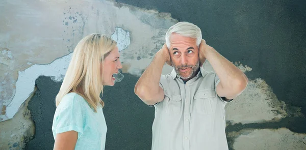 Unhappy couple having an argument with man not listening against rusty weathered wall