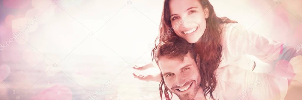 happy couple having fun in front of the sea at the beach