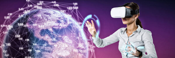 Female executive using virtual reality headset against pink and purple background