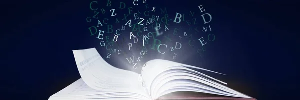 Digital composite of Opened book with light and letters on dark blue background