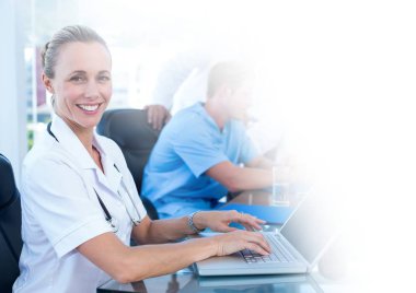 Bir dizüstü bilgisayarda çalışan kadın doktor dijital bileşik